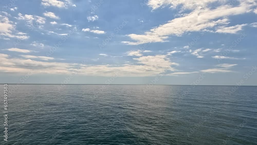Sea water surface. Aerial view on calm water surface, camera flies over clear sea ocean. Sun glare. Abstract nautical summer ocean nature. Holiday and travel. Weather and climate change. Slow motion Sea water surface. Aerial view on calm water surface, camera flies over clear sea ocean. Sun glare. Abstract nautical summer ocean nature. Holiday and travel. Weather and climate change. Slow motion