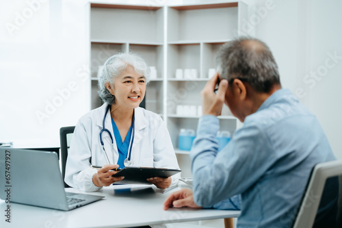 Senior man being examined by a doctor sitting at the table. Medicine and health care concept.