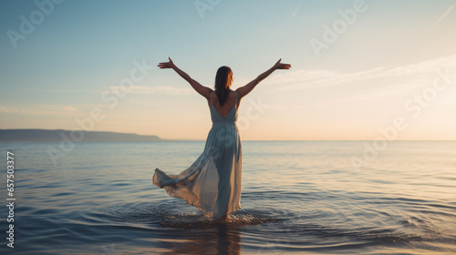 woman showing her arms up to the sky at the end of a beach