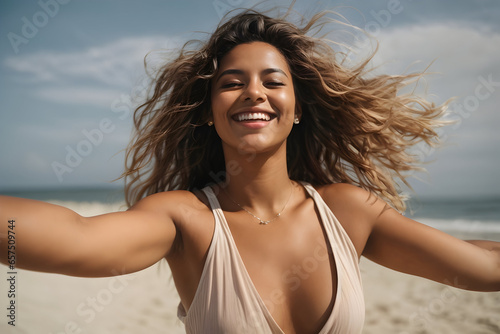 A young woman embraces the beauty of the beach and the freedom of the open air.