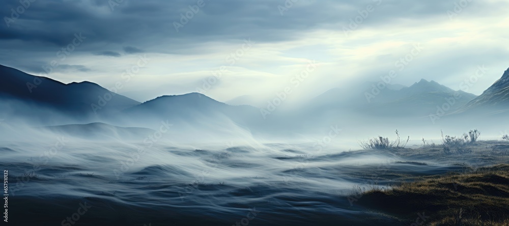 This wide-format background image capturing a serene scene where morning mist is gently blown by the wind across the undulating contours of a picturesque hill. Photorealistic illustration