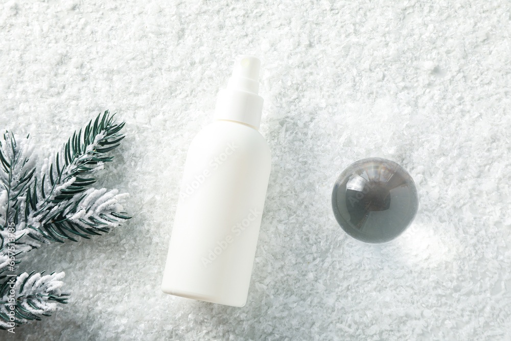 Cosmetic bottle and fir branch on light background, top view Cosmetic bottle and fir branch on light background, top view