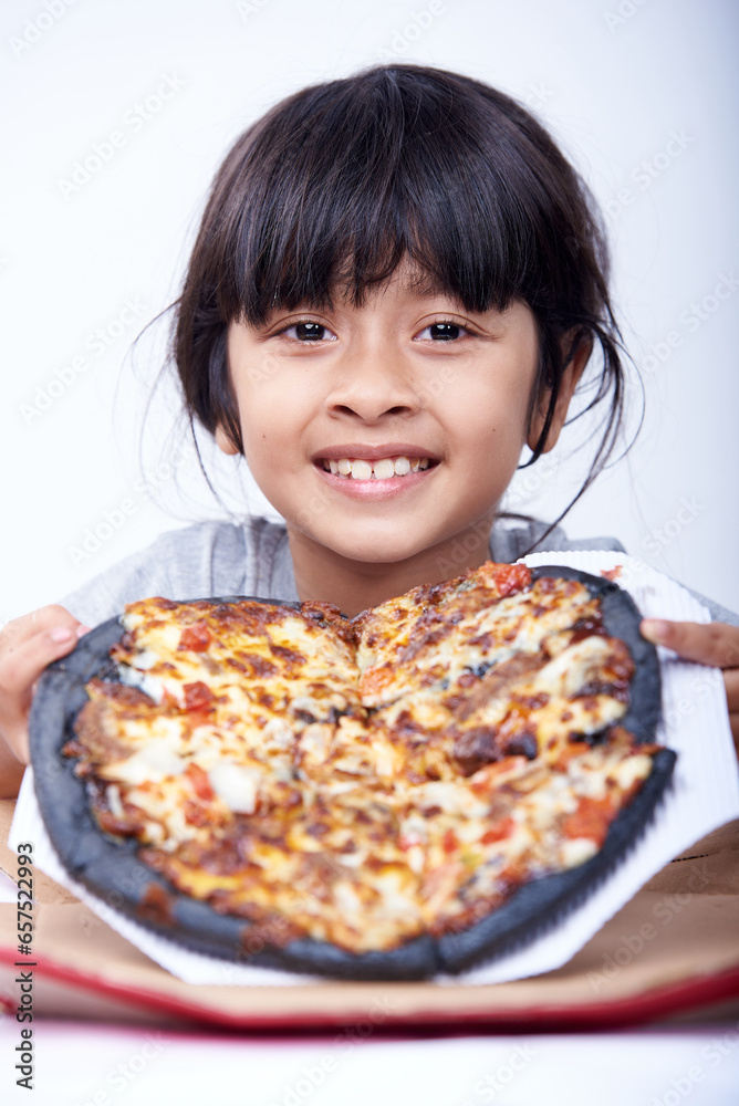 Cute little girl is holding a black pizza on a white background Cute little girl is holding a black pizza on a white background