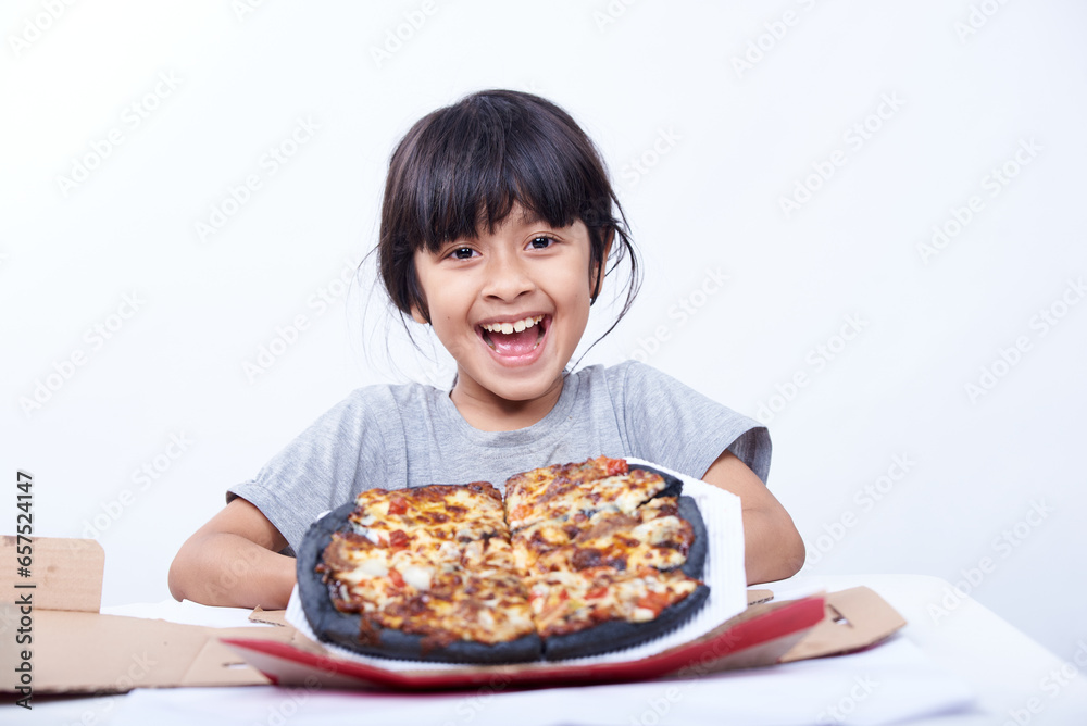 Cute little girl is holding a black pizza on a white background