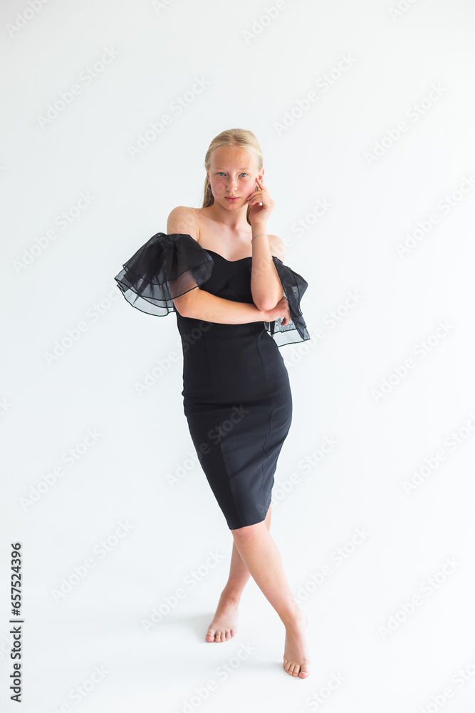 Young pretty blondie woman in black dress on isolated white background. Natural beauty, caucasian girl Young pretty blondie woman in black dress on isolated white background. Natural beauty, caucasian girl
