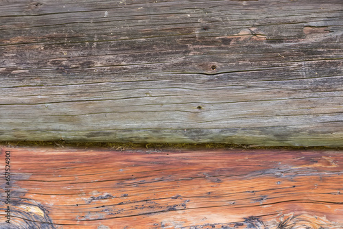 Old wooden logs in outside wall of medieval log building photo