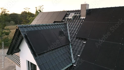 Arc shot of modern solar panels installed on the roof of a single-family house