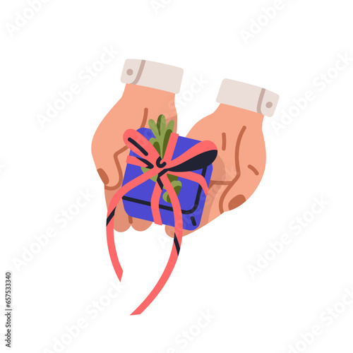 Hands hold holiday gift box. Presenting Christmas surprise wrapped in festive...