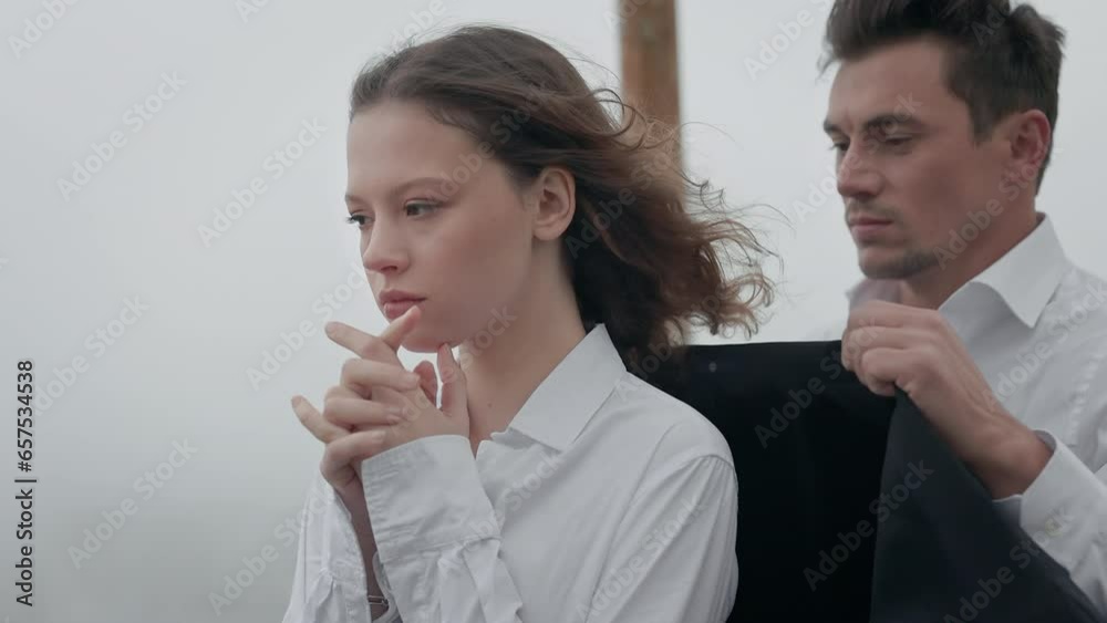 Charming Young Girl. Young Man Covers Her With Jacket. Charming Young Girl. Young Man Covers Her With Jacket.