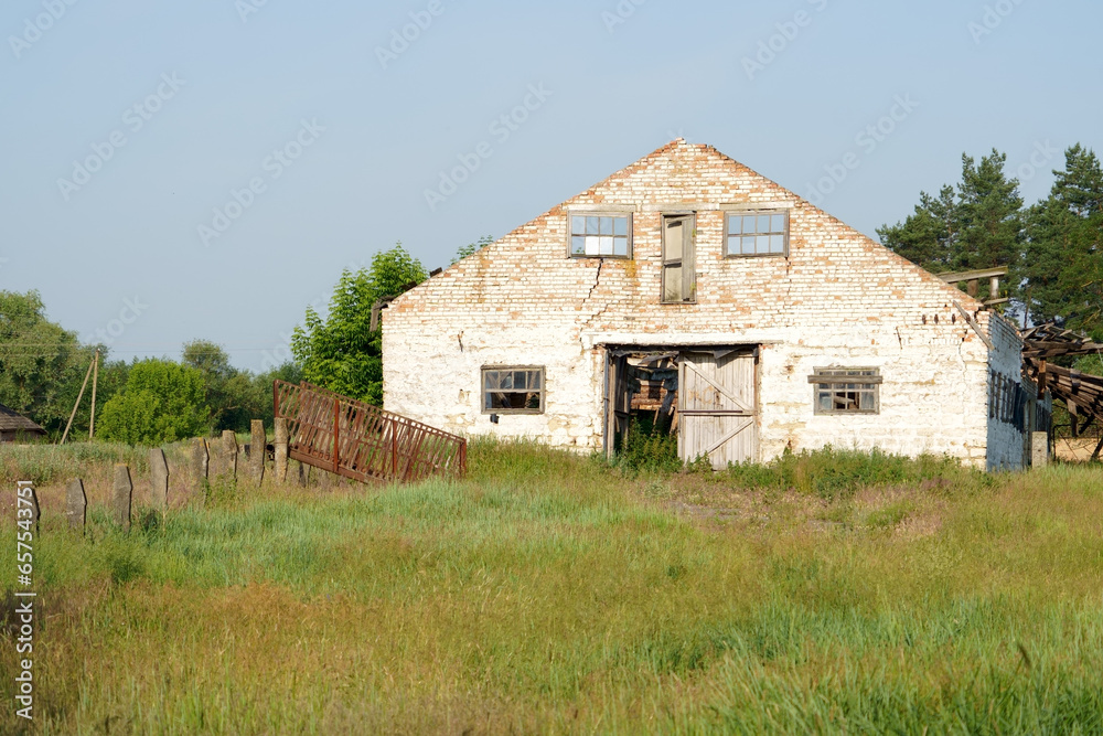 Depressed region of Ukraine. Dilapidation of the village. Untidy old buildings of a livestock farm. View of outskirts and destroyed buildings in village Depressed region of Ukraine. Dilapidation of the village. Untidy old buildings of a livestock farm. View of outskirts and destroyed buildings in village