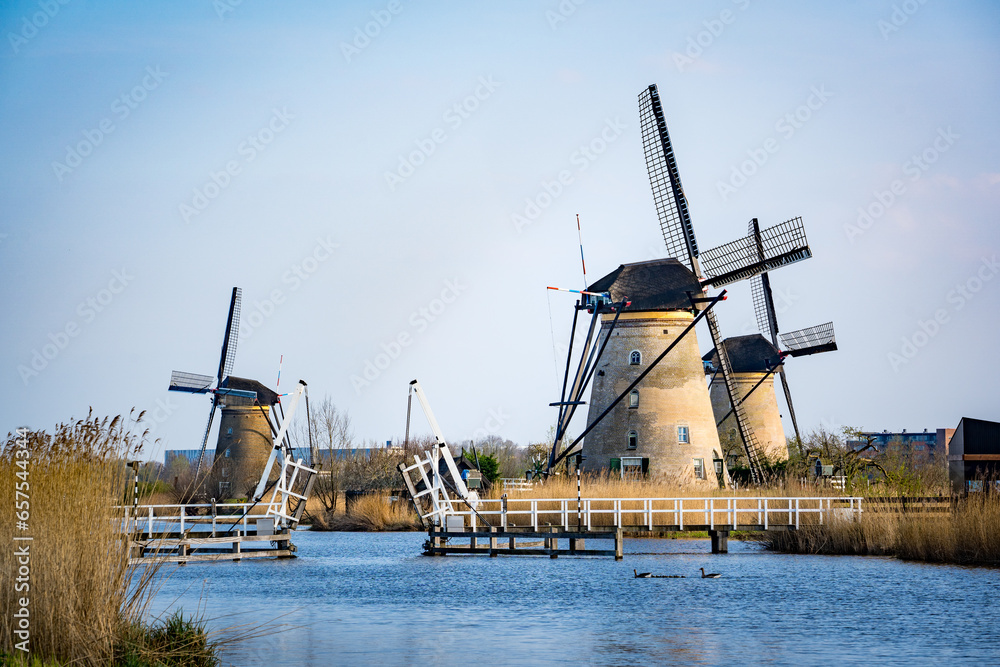 Naklejka premium windmills across the river in the netherlands