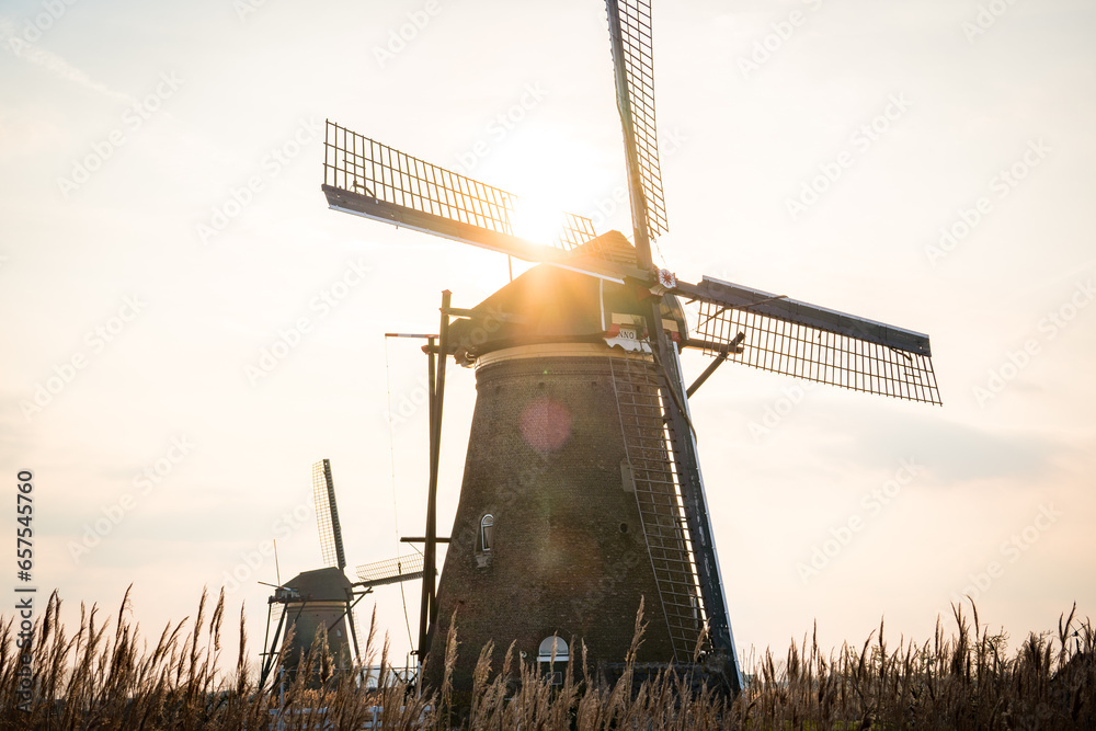 kinderdijk dutch windmill during sunrise - obrazy, fototapety, plakaty 