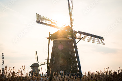kinderdijk dutch windmill during sunrise photo