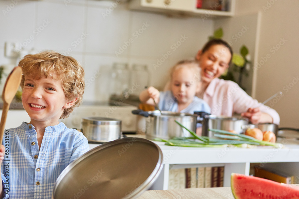Happy boy having fun with family in kitchen at home