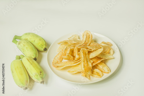 Sweet banana crisp in a wooden bowl . Is a popular Thai dessert in Thailand . a type of dessert preservation. Isolated on white background
