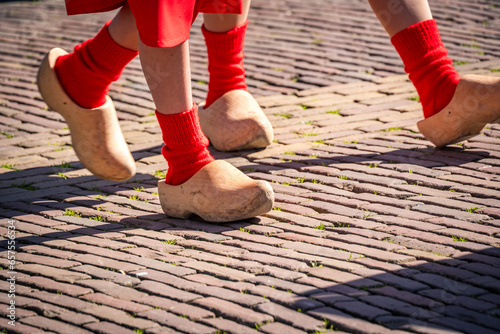 dutch women walking in traditional wooden shoes at alkmaar cheese market photo