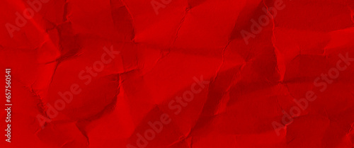 Crumpled red paper background close up, red cardboard texture.
