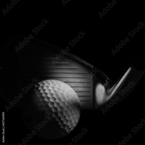 Moody Golf Concept on a Black Background showing Iron Club Face and Ball