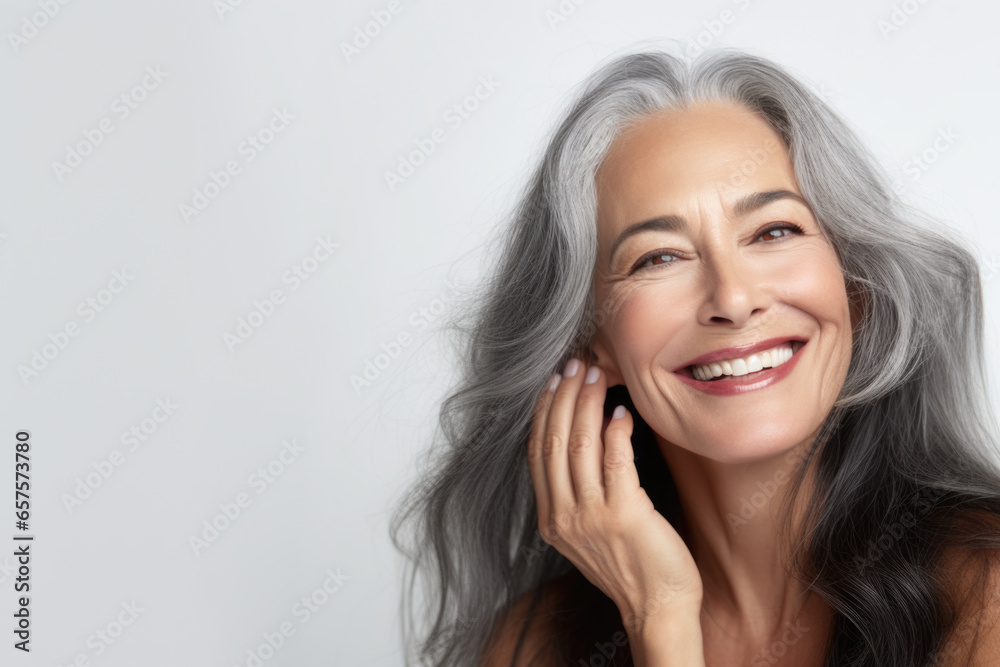 Portrait of a beautiful ageing mature woman with long grey hair. Healthy face and skin care beauty, cosmetics, cosmetology concept. Portrait of a beautiful ageing mature woman with long grey hair. Healthy face and skin care beauty, cosmetics, cosmetology concept.