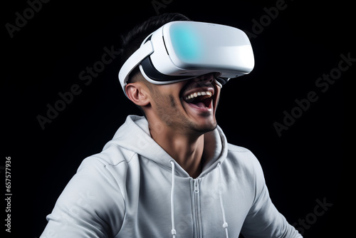 Portrait of a young man wearing virtual reality goggles, white background. Future technology concept.