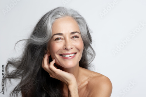 Portrait of a beautiful ageing mature black woman with long grey hair. Healthy face and skin care beauty, cosmetics, cosmetology concept.