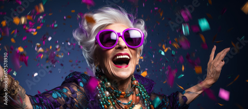 Old lady Surprised and excited, opening eyes and mouth in outrageous party clothing and bright sunglasses, Bright solid orange and purple color background © MD Media
