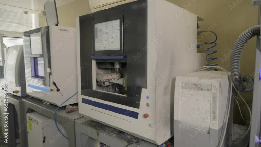 Dental laboratory with equipment for artificial denture fabrication. Dental clinic laboratory CAD milling equipment producing tooth crowns. Dental laboratory equipment making artificial teeth