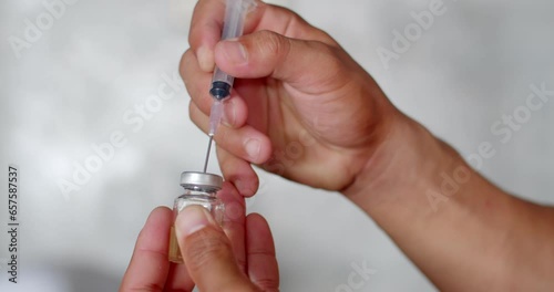 Check the dose in the syringe and remove the air from the syringe.Syringe with liquid being drawn into syringe.Testosterone. photo
