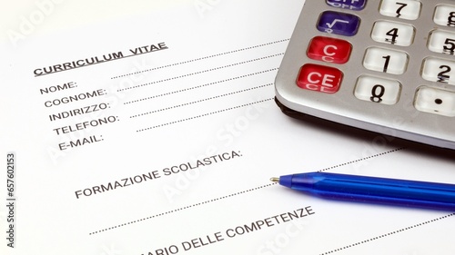 Curriculum Vitae una forma italiana, curriculum vitae vuoto con una penna e una calcolatrice. photo