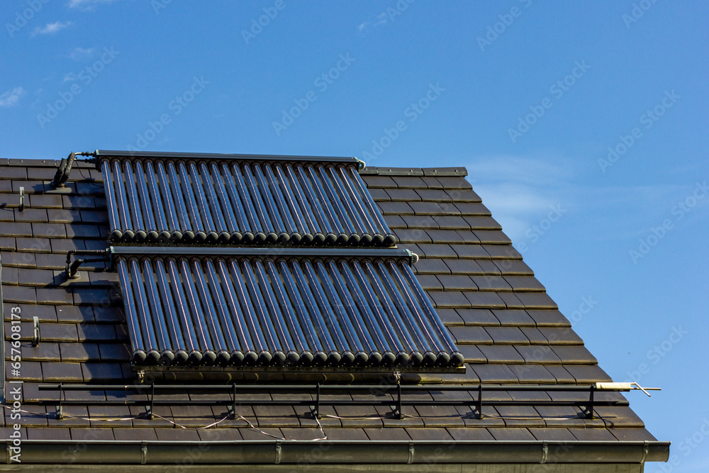 Fototapeta premium solar water collectors on rooftop