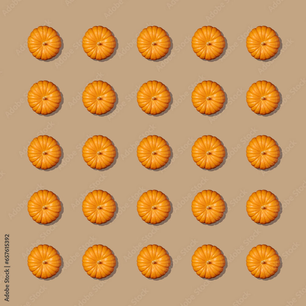 Pattern with a pumpkin on beige background. Autumn pumpkin background. Top view. Pattern with a pumpkin on beige background. Autumn pumpkin background. Top view.
