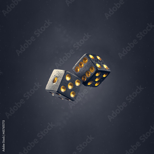 Two black dice are falling on a dark gray background. Photo with bokeh.