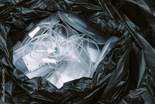 Close-up of toxic waste in garbage bags, acetate ringer's injection, saline bottles and Syringes, from clinics or hospitals for recycling photo