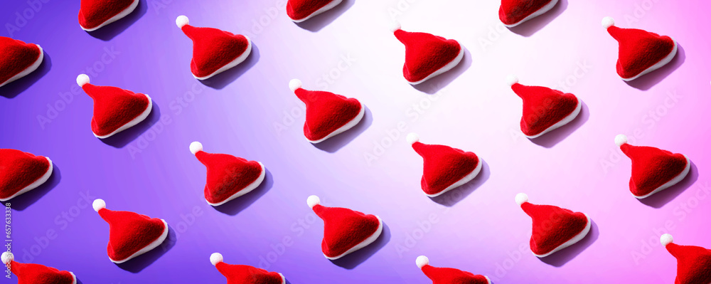 Pattern of small santa hats - overhead view flat lay Pattern of small santa hats - overhead view flat lay