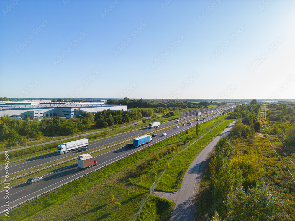 Aerial view of goods warehouse. Logistics center in industrial city zone from above. Aerial view of trucks loading at logistic center stock photo