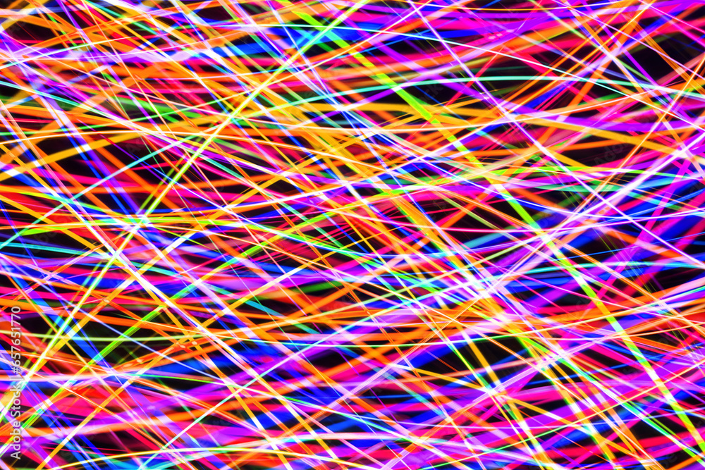 Night market banner. Neon lights background. Motion lines texture. Long exposure moving light pattern. Abstract night life background. Glowing lines design. Colorful illumination. Night market banner. Neon lights background. Motion lines texture. Long exposure moving light pattern. Abstract night life background. Glowing lines design. Colorful illumination.