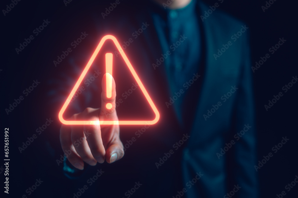 Hand showing red triangle caution warning sign for maintenance notification error and risk concept, protecting data personal information on social network. privacy data security, risk management - obrazy, fototapety, plakaty 