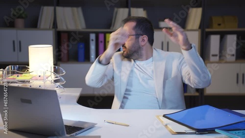 Businessman working at night is angry.