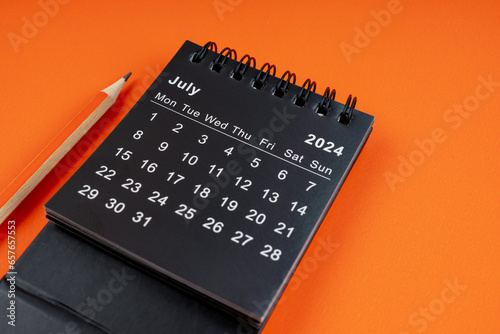 July 2024 desk calendar with pencil.