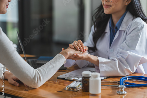 Close up hands Woman doctor holding hands patient encourage cheer up a consultation at hospital medicare clinic. Doctor talking to patient support giving hope mental health therapy consoling recovery