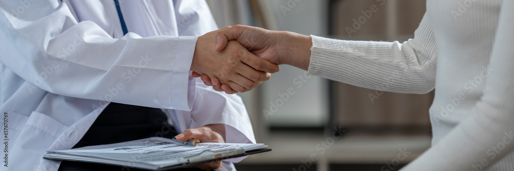© crizzystudio - Doctor shakes hands with his patient in the office, after successful treatment of specialty and delighted patients returned home, a handshake concept to congratulate.