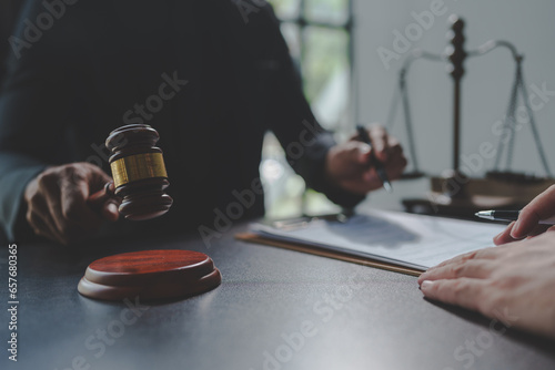 Lawyer or judge holding Hammer prepares to judge the case with justice, and litigation, scales of justice, law hammer, Legal consulting services, Concept of litigation, and legal services. © crizzystudio