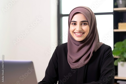 Muslim woman working in home office. 