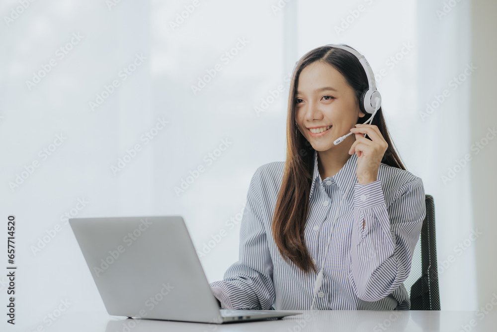 Portrait of Asian female call center operator with headset working support hotline in modern office Smiling Asian woman talking to customer service through headset Portrait of Asian female call center operator with headset working support hotline in modern office Smiling Asian woman talking to customer service through headset