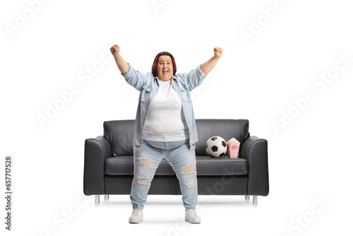 Happy corpulent woman cheering with hands up