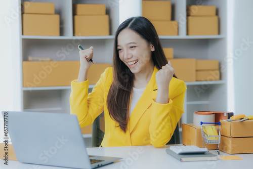 small business entrepreneur Freelance Asian woman working in office Young successful Asian woman with her packaging boxes, online marketing and shipping.