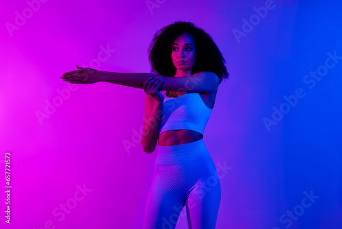Portrait of gorgeous stunning fitness blogger lady stretching arm warm up isolated on colorful neon color background