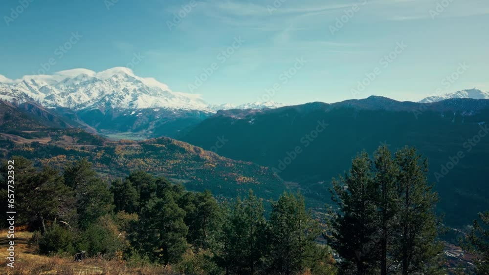 Aerial view of young woman walking up a mountain in Georgia in autumn, with scenic snow covered mountains on the background, Tourist travel enjoying nature and life concept. Aerial view of young woman walking up a mountain in Georgia in autumn, with scenic snow covered mountains on the background, Tourist travel enjoying nature and life concept.