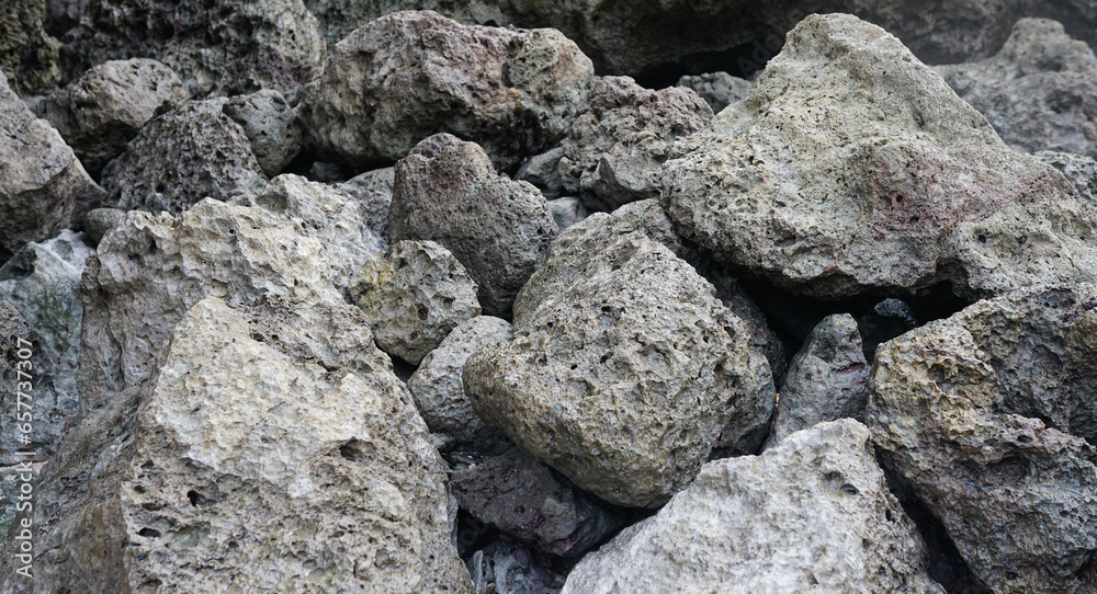 Rock fragments from volcano, coral rocks on beach