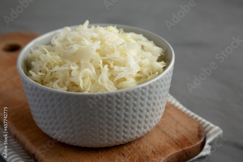 Homemade German Sauerkraut in a Bowl on a gray background, side view.